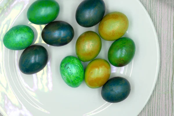 bir hasır yeşil bir yuvada beyaz yumurta yuvarlak sepet, kareler ve modelleri, beyaz bir arka plan üzerinde renkli masa örtüsü