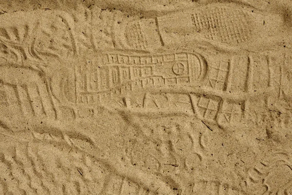 marks from shoes on the sand