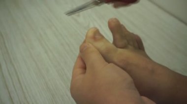 Uzun kesme yetişkin beyaz adam yürüyerek makasla tırnaklar. Banyo banyo closeup ayak tirnak kesmek .