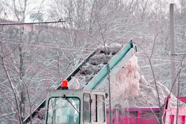 Clearing the road from snow scoop scraper