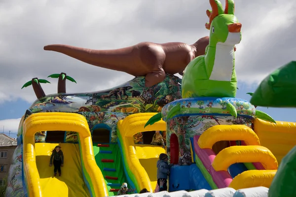 Happy excited girl having fun on inflatable attraction playground. Россия Березники 26 мая 2019 — стоковое фото