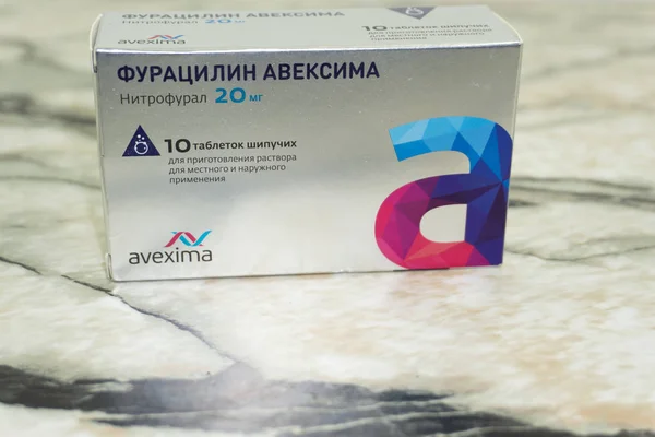 Furatsilin aveksima black label Open medicine packet with blister pack of pills, isolated on white. Россия Березники 28 сентября 2018 — стоковое фото