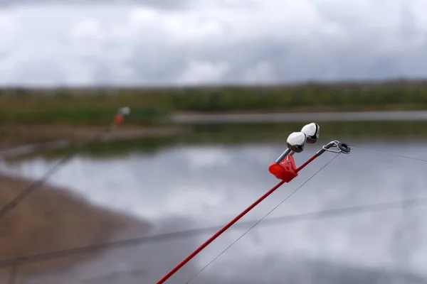 Fishing bell at the end of a fishing rod. Bells will ring when the fish is hooked .