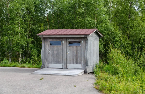 Lapland Finland, toilet on the side of a parking lot on a summer day