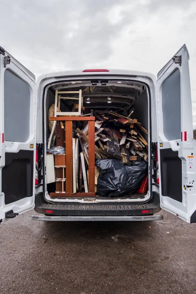 White work van full of debris and on its way to recycling