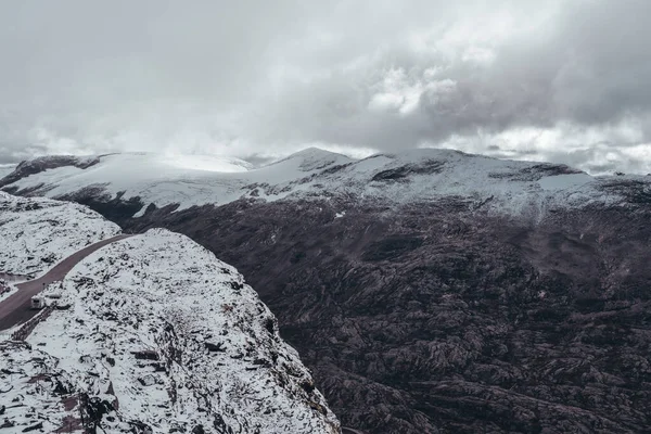 在大雪纷飞的山地风景的路边 挪威达尔斯班巴 免版税图库照片