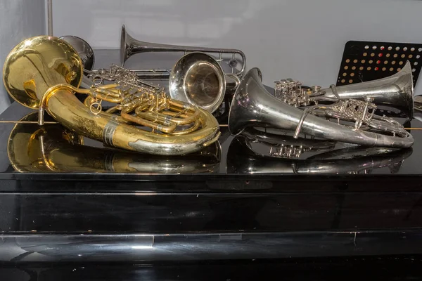 Konser öncesi siyah bir piyanoda rüzgar aletleri yalan