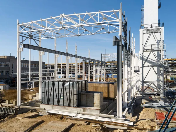 Construction site of modern chemical production in the process of assembling of cryogenic air separation department with metal structures and equipment in containers under clear deep blue sky.