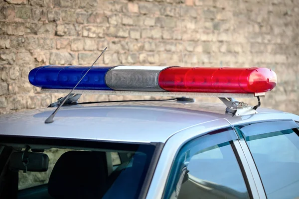 Flashing lights and antennas on roof of traffic police patrol car as symbol of priority in traffic with copy space.