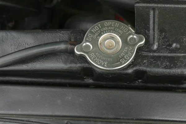 Silver radiator cap with warning — Stock Photo, Image