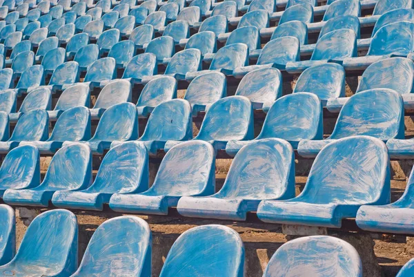 Many old blue chairs in a football stadium, for visitors needing replacement or reconstruction