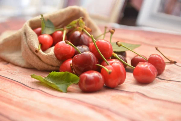 red fresh cherry fruit on wooden table