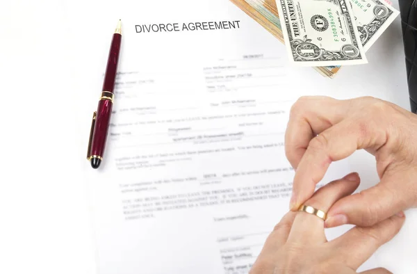 Divorce agreement. Woman taking out wedding ring after the divorce