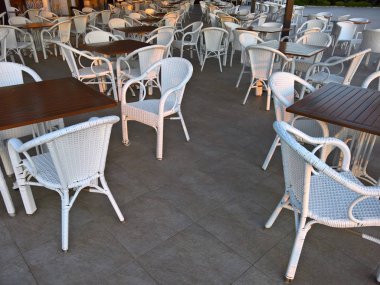 Tables and chairs in summer resort early morning