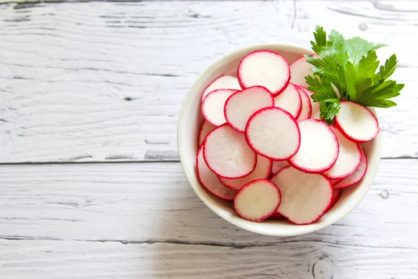 Closeup radish slices in the bowl. Raw radish slices ready to eat.