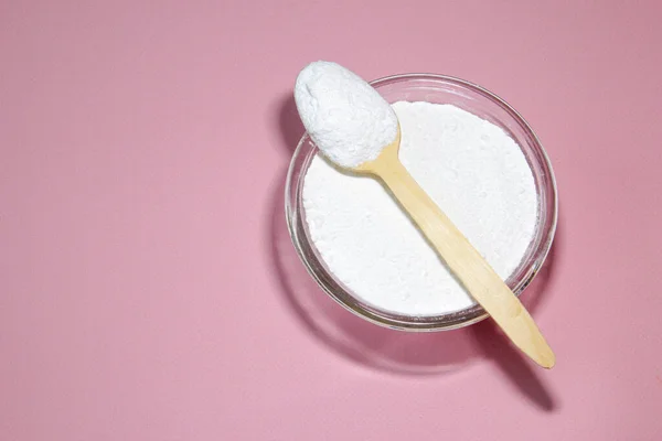 Collagen powder on pink background. Extra protein intake. Natural beauty and health supplement for skin, bones, joints and gut. Flatlay, top view. Copy space. — Stock Photo, Image