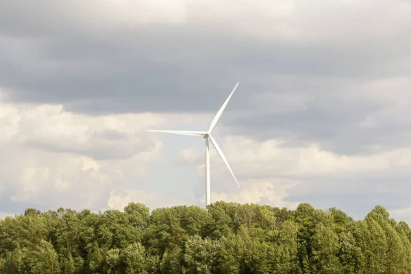 Wind turbine in the forest near the road — Stock Photo, Image