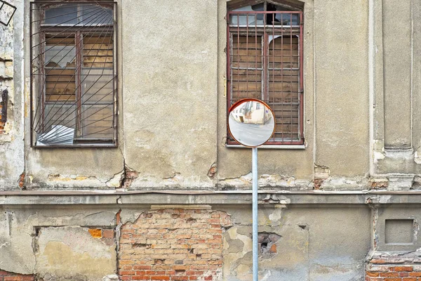 Abandoned grunge cracked stucco wall with with boarded up windows — Stock Photo, Image