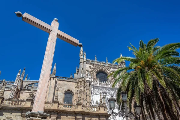 Stone Cross and Seville Cathedral — Stock Photo, Image
