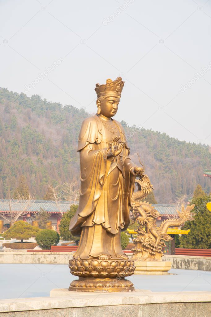 chinese god statue and on lotus flower statue