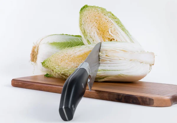 Two half of Chinese cabbage with knife on chopper board isolated on white background — Stock Photo, Image