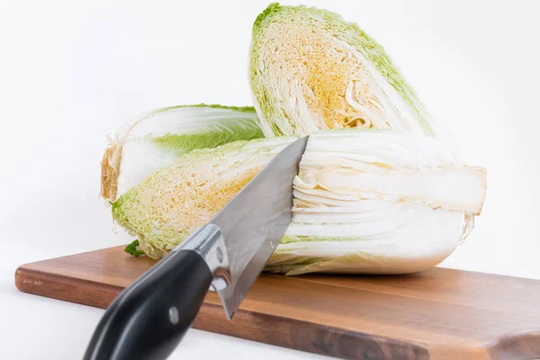 Two half of Chinese cabbage with knife on chopper board isolated on white background — Stock Photo, Image