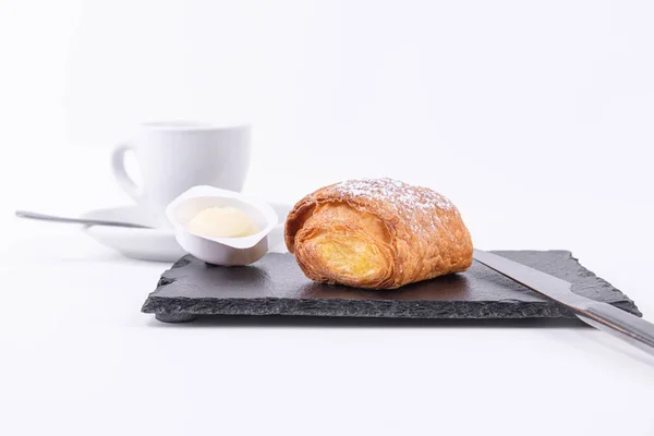 Breakfast of coffee and a puff pastry roll freshly baked with butter — Stock Photo, Image