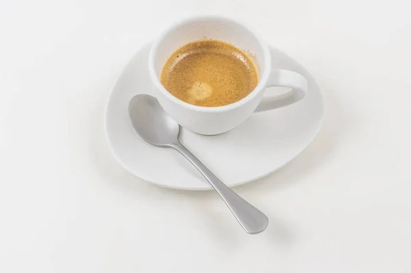 Detail eines weißen Kaffeeglases mit einem isolierten Löffel auf weißem Hintergrund — Stockfoto