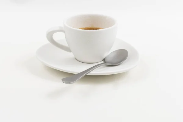 Un vaso de café blanco con una cuchara sobre un fondo blanco — Foto de Stock