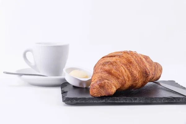 Foto detail van een croissant, boter en koffie — Stockfoto
