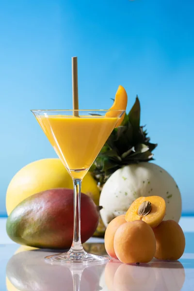 Заманчивый бокал мартини с абрикосовым соком и соломинкой — стоковое фото