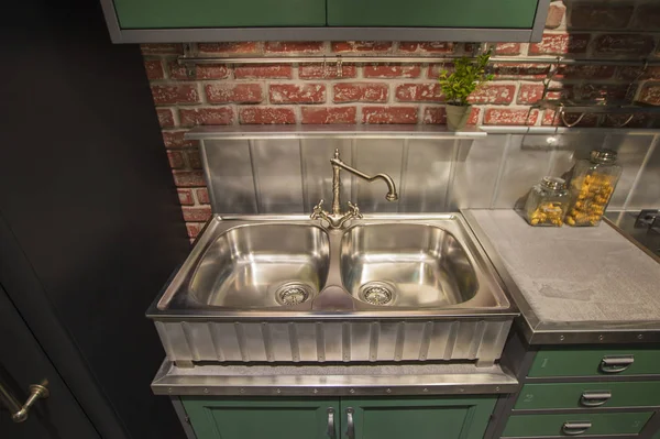 Kitchen cabinet with double steel sink in english style, green table, silver luxury faucet kitchen.