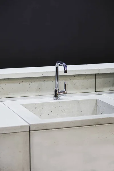 Modern kitchen, the water tap and concrete kitchen sink.  Concrete kitchen with a tap and gray worktop