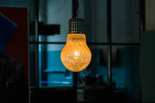Industrial pendant lamps against wall. Loft interior. Edison bulbs. Concept interior lighting
