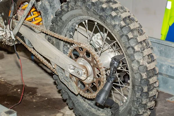 Close up view of dirty motorbike wheel isolated. Transport background. Car repair shop. Service. Garage.