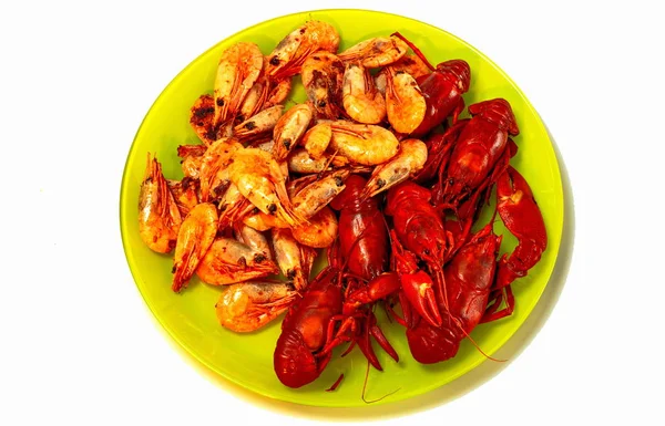 Closeup view of plate with shrimps and crayfish. Traditional  summertime eating and drinking celebration in the Nordic countries. Seafood. Healthy eating.