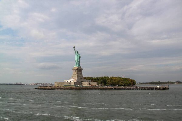 Beautiful view of famous Statue of Liberty and Manhattan on background. Liberty Island in New York Harbor in New York.