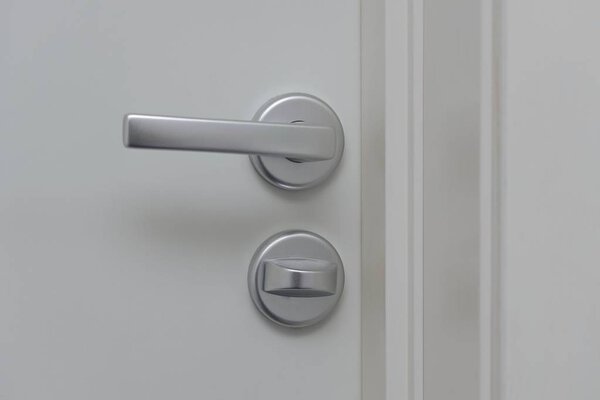 Close up view of lock on white door. Interior design. Beautiful backgrounds.