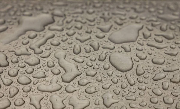 Beautiful background texture of rain water drops on grey black metal surface. Beautiful backgrounds.