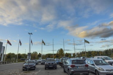 Arabalar park yerinde, muhteşem mavi gökyüzünde, beyaz bulutların arkasında. 10.24.2020. Uppsala. İsveç.