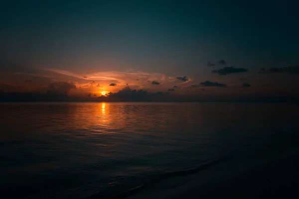 Maldives at sunset. Sea, clouds, silhouettes. Spring, 2019