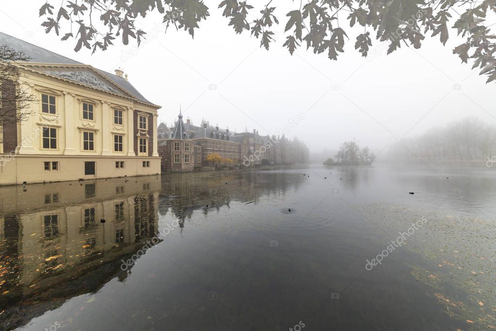 Misty morning on Hofvijver, Dutch parliament reflected on the calm water at The Hague