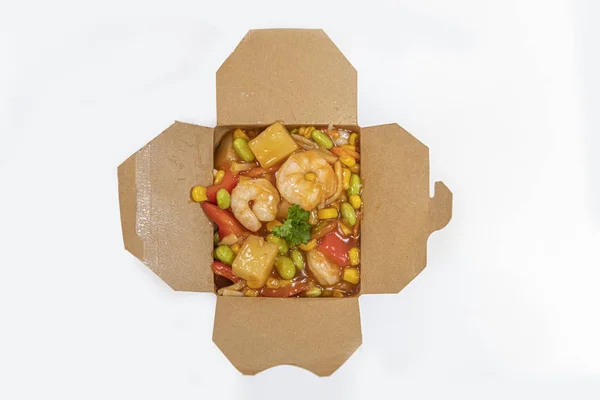 Box of stir fried chicken and shrimps noodle served in a paper box for take away