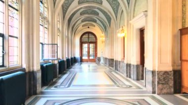 Walking through a Victorian Demeure corridor toward a wooden closed door