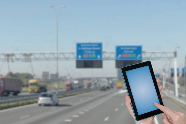 骑着高速公路的信息图概念 手指触摸平板电脑蓝色空白屏幕准备为您的文本 在背景中故意模糊的高速公路图像 删除所有潜在商标 — 图库照片