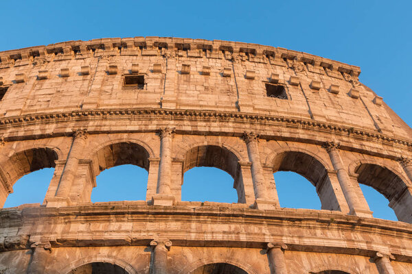 Front view of the arcs of Colosseum in sunset light. Rome Italy. Horizontally