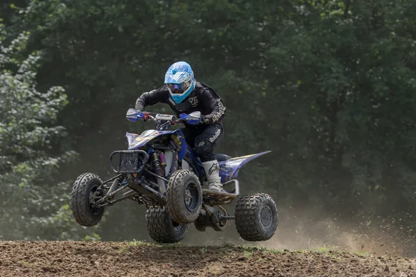 Closeup shot of quad rider in black jumping — Stock Photo, Image