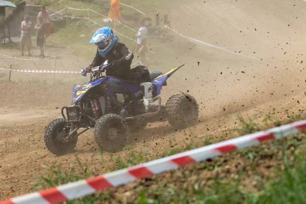 Young rider in black on a quad bike is a passing turn — Stock Photo, Image