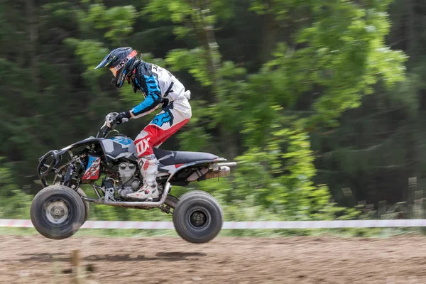 Panning side shot of quad rider jumping in the race — Stock Photo, Image