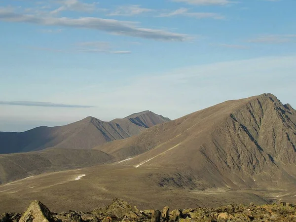 View from a high mountain in the tundra. Views of rivers, lakes, mountains and nearby mountains are photographed from the peaks of the Ural Mountains.